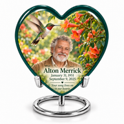 Hummingbird 01 large Heart urn with a ruby-throated hummingbird hovering at orange trumpet vine, fictional Alton Merrick portrait, January 31, 1951 and September 9, 2025, a remembrance quote and silver ring stand.