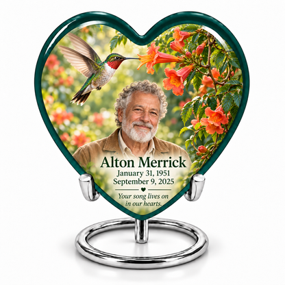 Hummingbird 01 large Heart urn with a ruby-throated hummingbird hovering at orange trumpet vine, fictional Alton Merrick portrait, January 31, 1951 and September 9, 2025, a remembrance quote and silver ring stand.