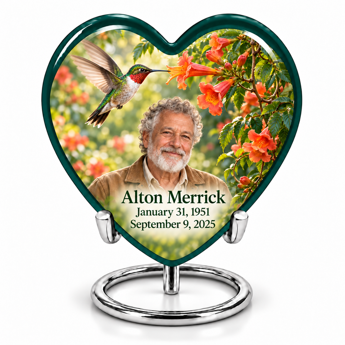 Hummingbird 01 single Heart keepsake with a ruby-throated bird at coral-orange trumpet flowers, fictional Alton Merrick portrait and full dates, without quote, on a complete silver ring stand.