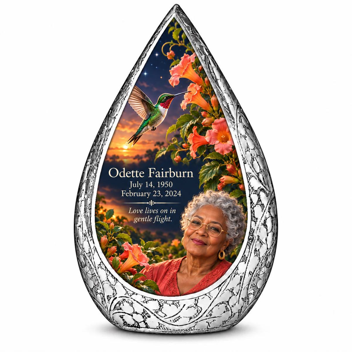 Hummingbird 01 Straight Drop, 10 inch large Urn: original engraved silver frame surrounding a ruby-throated hummingbird, peach-coral trumpet vine and apricot-to-navy dusk; fictional Odette Fairburn portrait, name and full dates.
