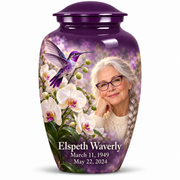 One 10-inch large Classic urn with violet hummingbird above white orchids, fictional Elspeth Waverly portrait with silver braid and violet glasses, name and full memorial dates on white.
