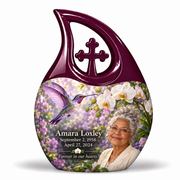 Hummingbird 02 Cross Drop, large urn: violet hummingbird and white orchids, solid plum loop with cross; Amara Loxley portrait, name and full dates on a white backdrop.