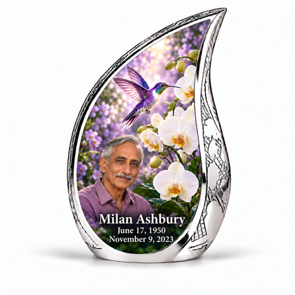 Hummingbird 02 Curved Drop, single keepsake: violet hummingbird above white orchids and lilac garden inside a complete engraved silver frame; Milan Ashbury portrait, name and full dates.