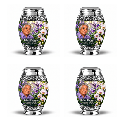 Four identical 3-inch Monar keepsakes with silver scroll bands, violet hummingbird, white orchids and fictional Rafael Dunmore portrait, name and full memorial dates.