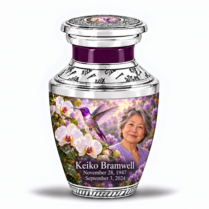 One 3-inch Tasty keepsake with near-flat silver lid and violet hummingbird-white orchid inset, solid purple neck, matching body artwork and fictional Keiko Bramwell portrait and dates.