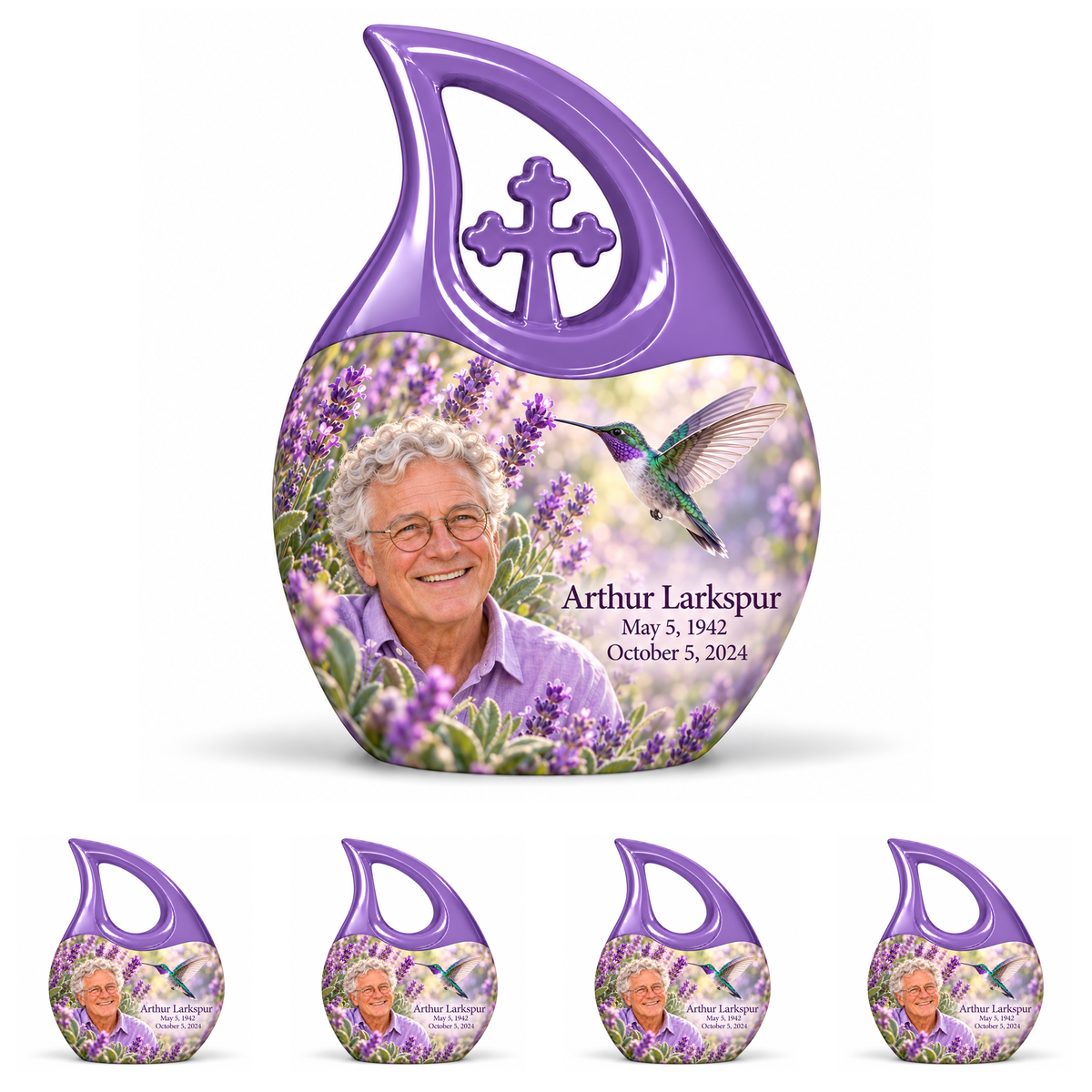 One large lavender Cross Drop urn with cross above four matching open-loop keepsakes, with lavender hummingbird art and Arthur Larkspur portraits.