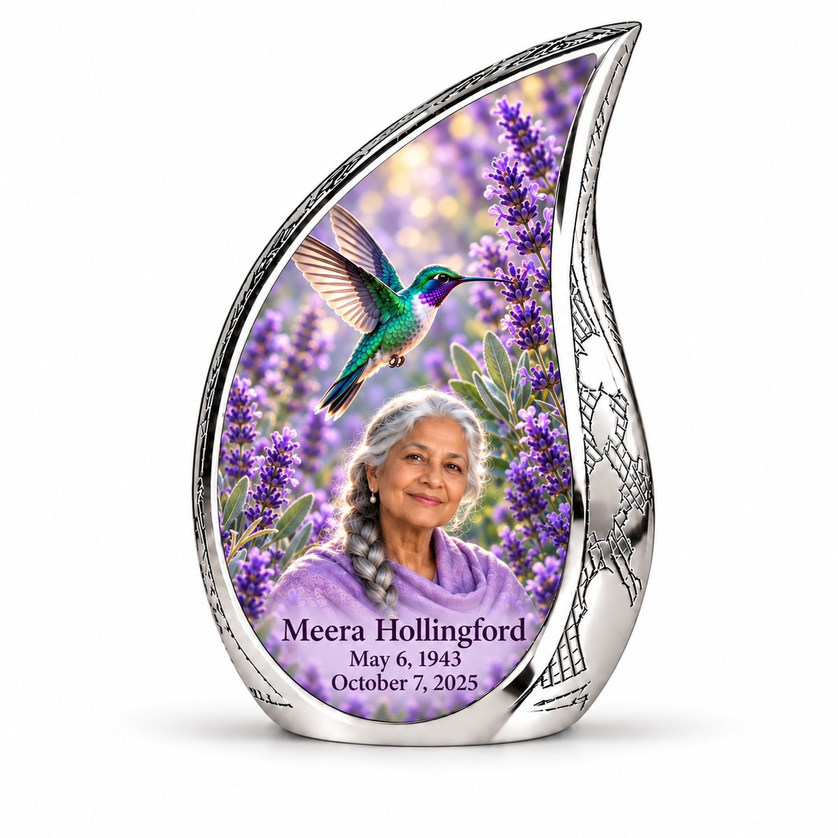 Curved Drop keepsake with swept silver tip, engraved silver sidewall, lavender hummingbird garden and silver-braided Meera Hollingford portrait and full dates.