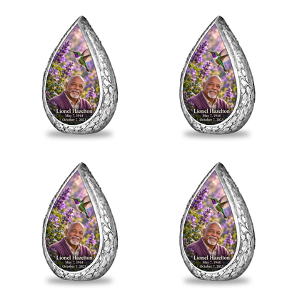 Four matching keepsakes Straight Drop memorial urn, emerald and violet hummingbird at lavender flowers, Lionel Hazelton portrait and full memorial dates, white background.
