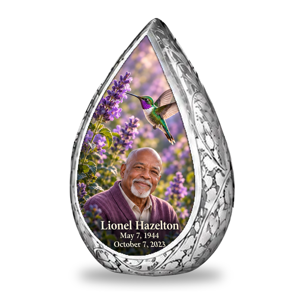Single keepsake Straight Drop memorial urn, emerald and violet hummingbird at lavender flowers, Lionel Hazelton portrait and full memorial dates, white background.