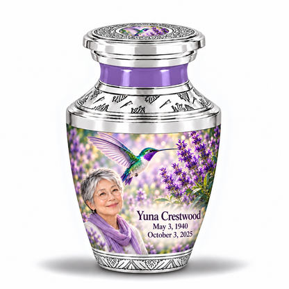 One 3-inch Tasty keepsake with near-flat silver lid and central art inset with silver engraved trim, solid lavender necks, green-violet hummingbirds at lavender and fictional Yuna Crestwood portraits, May 3, 1940 to October 3, 2025.