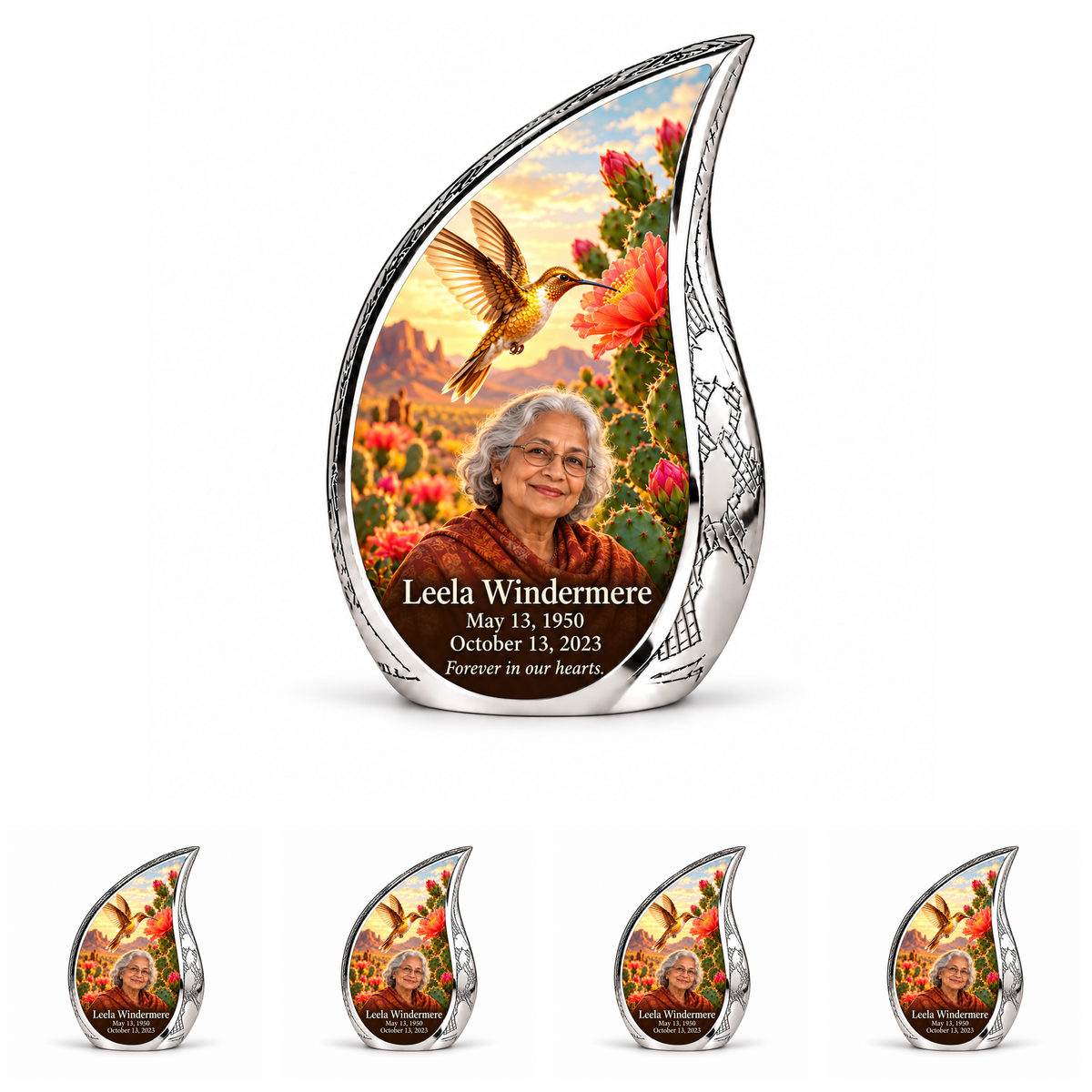 Large engraved silver Curved Drop urn above four matching keepsakes with golden hummingbird, cactus blooms and Leela Windermere personalization.