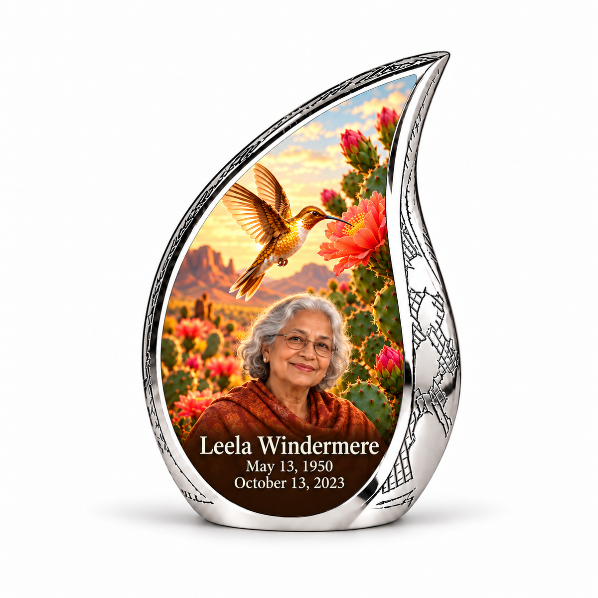 Silver Curved Drop keepsake with golden desert hummingbird, pink cactus blossoms and Leela Windermere portrait and full dates.