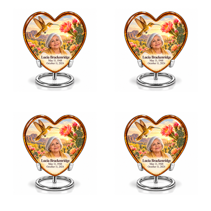 Four identical amber Heart keepsakes with golden hummingbirds, pink cactus blossoms and Lucia Brackenridge portraits on complete silver ring stands.