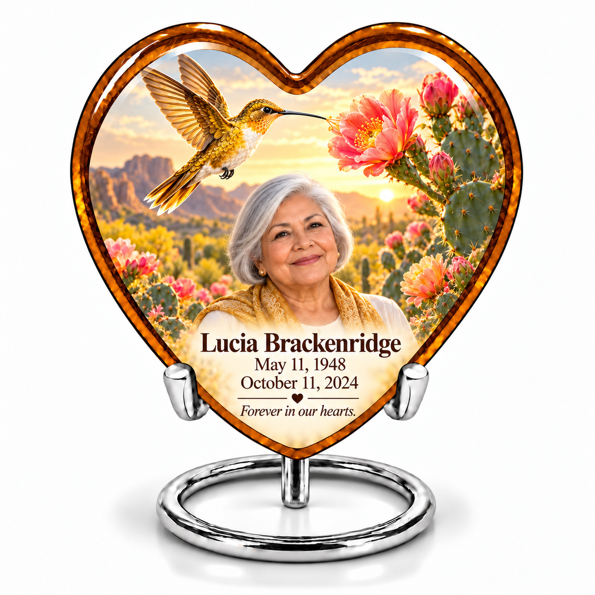 Amber Heart urn on silver ring stand with golden hummingbird, pink cactus blooms and Lucia Brackenridge portrait and full dates.