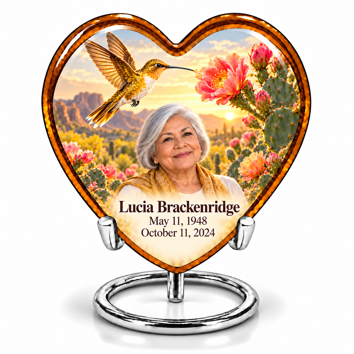Amber Heart keepsake with golden hummingbird, desert cactus flowers and Lucia Brackenridge portrait, name and full dates on silver stand.