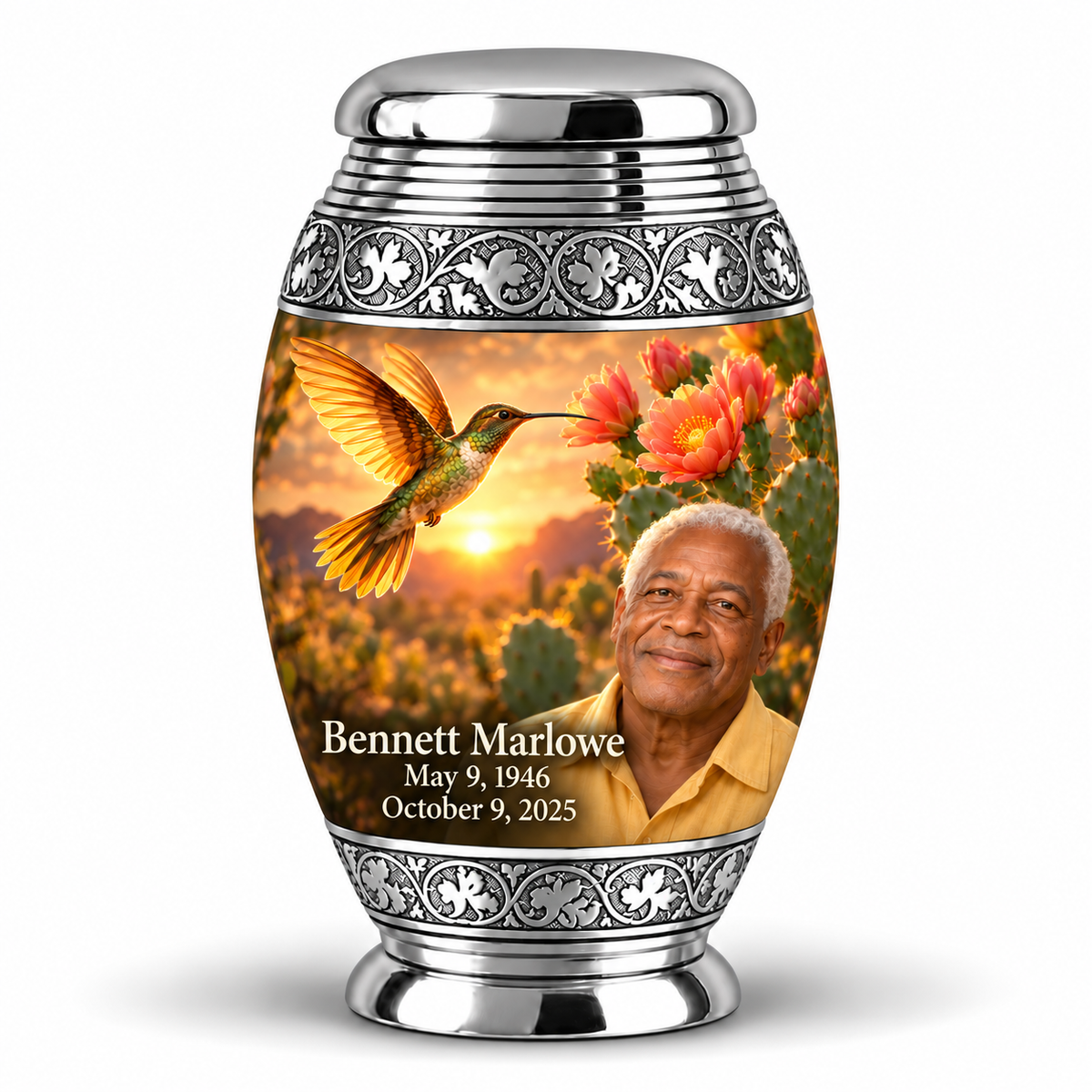 One Monar keepsake with silver scroll bands, golden hummingbird over desert blooms and Bennett Marlowe portrait and full dates.