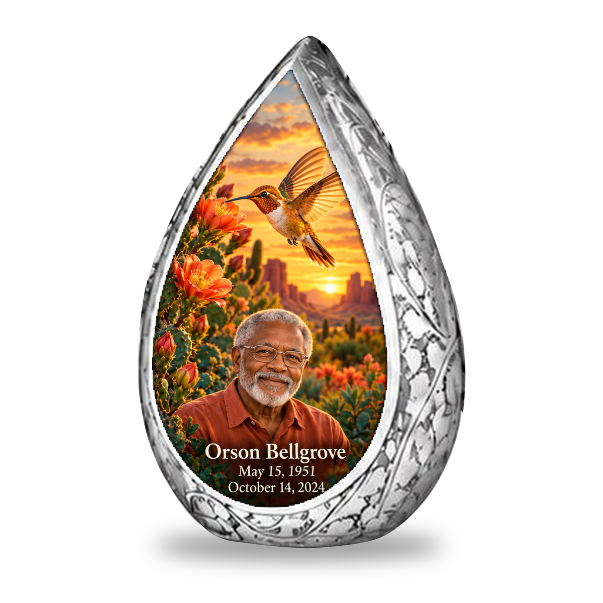Single keepsake Straight Drop memorial urn, golden hummingbird at orange desert cactus blooms, Orson Bellgrove portrait and full memorial dates, white background.