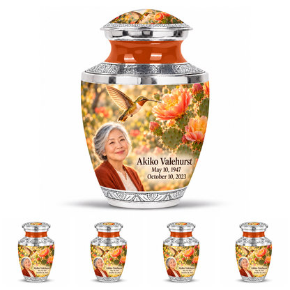 One large Tasty urn above four matching keepsakes with silver trim, orange necks, golden hummingbirds, coral cactus flowers and Akiko Valehurst memorial portraits.