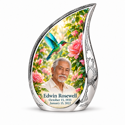 10 inch large Urn; Engraved silver Curved Drop with vivid turquoise and icy cyan hummingbird wings above soft pink roses and green leaves. Edwin Rosewell has a narrow angular East Asian face, swept-back silver hair, small white beard and cream shirt. Dark teal name and October 15, 1935 / January 15, 2022 dates are accurate.