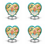 4 Keepsake 3 inch Urns; Glossy turquoise Heart with turquoise-winged hummingbird above soft pink roses and a cream garden. Malcolm Dewhurst has a broad triangular clean-shaven face, curved nose, dark brows, thick swept silver hair and turquoise shirt. Dark teal name and October 13, 1933 / January 13, 2024 dates are accurate.