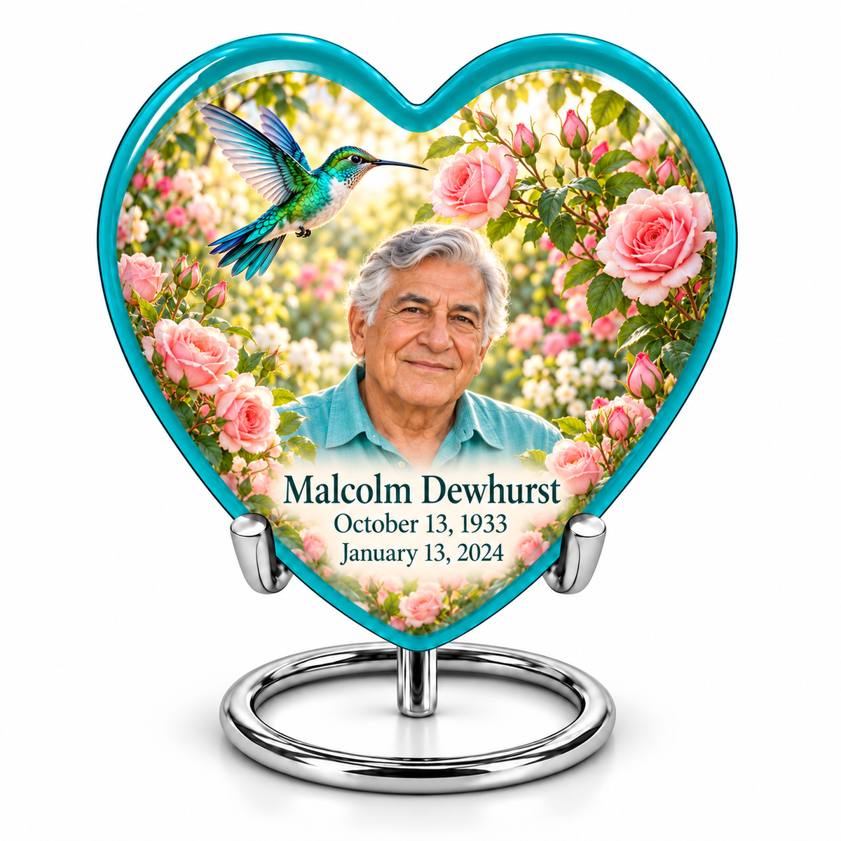 10 inch large Urn; Glossy turquoise Heart with turquoise-winged hummingbird above soft pink roses and a cream garden. Malcolm Dewhurst has a broad triangular clean-shaven face, curved nose, dark brows, thick swept silver hair and turquoise shirt. Dark teal name and October 13, 1933 / January 13, 2024 dates are accurate.