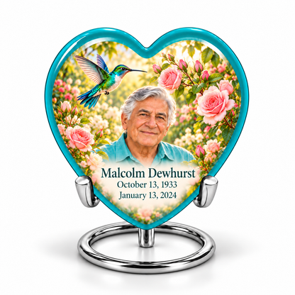 1 Keepsake 3 inch Urn; Glossy turquoise Heart with turquoise-winged hummingbird above soft pink roses and a cream garden. Malcolm Dewhurst has a broad triangular clean-shaven face, curved nose, dark brows, thick swept silver hair and turquoise shirt. Dark teal name and October 13, 1933 / January 13, 2024 dates are accurate.