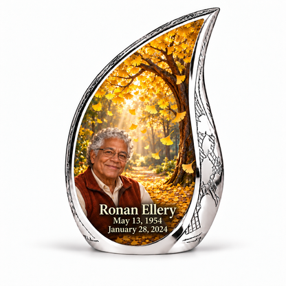 Tree of Life 20 Curved Drop, 1 Keepsake 3 inch Urn: golden ginkgo fan leaves falling through amber sunlight; fictional Ronan Ellery portrait, name and full dates, engraved silver frame.