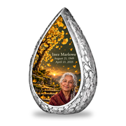 Tree of Life 20 Straight Drop, 1 Keepsake 3 inch Urn: original engraved silver surrounding golden ginkgo fan leaves, olive dusk sky and mossy stone steps, with fictional Inez Marlowe portrait, name and full dates.